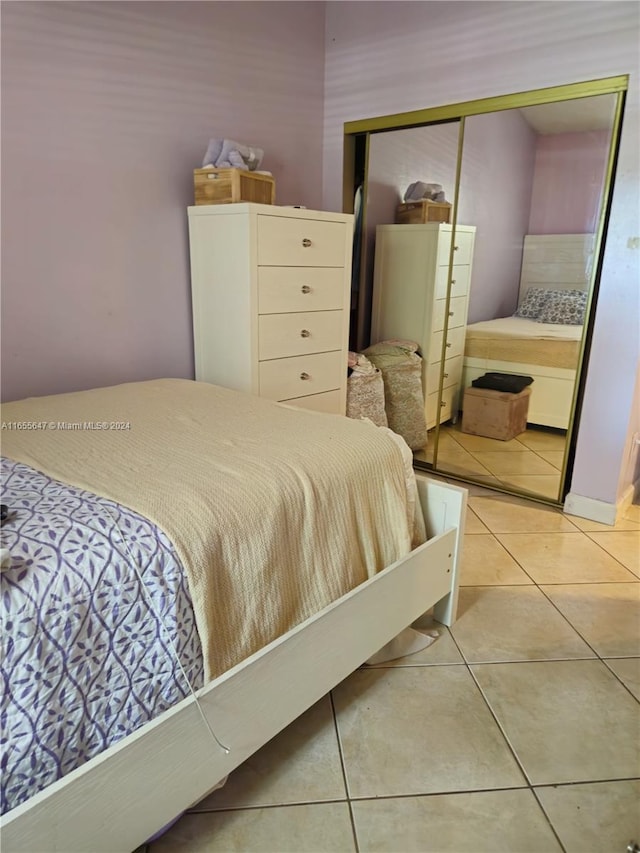 bedroom with a closet and light tile patterned floors