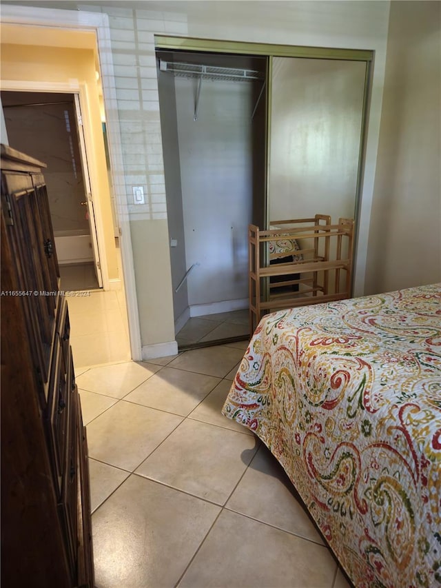 bedroom with a closet and tile patterned floors