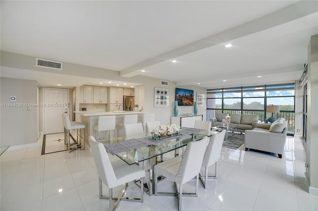 tiled dining space with expansive windows and sink