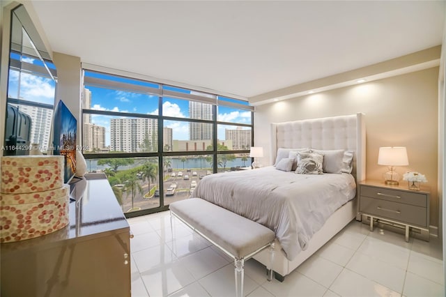 tiled bedroom with floor to ceiling windows and a water view