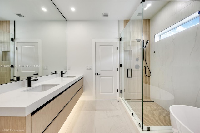 full bath with a stall shower, marble finish floor, and a sink