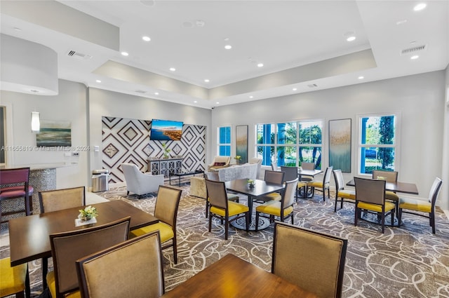 dining area featuring visible vents, recessed lighting, a raised ceiling, and wood finished floors