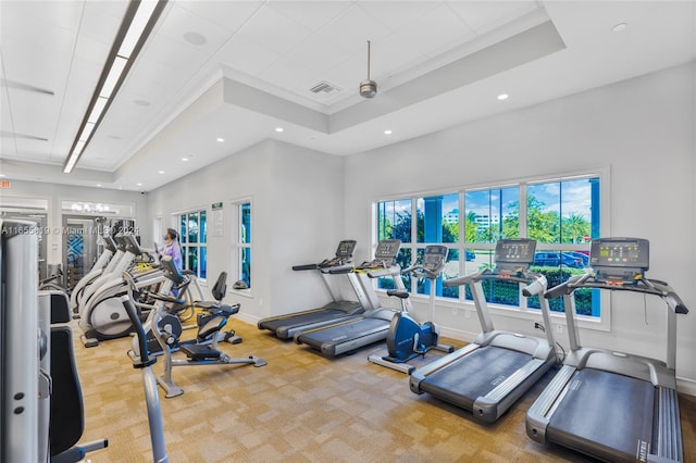 gym featuring visible vents, baseboards, a raised ceiling, and carpet