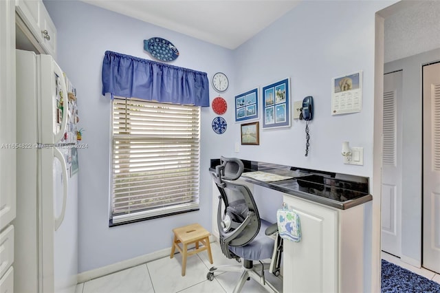 office with a textured ceiling and light tile patterned floors