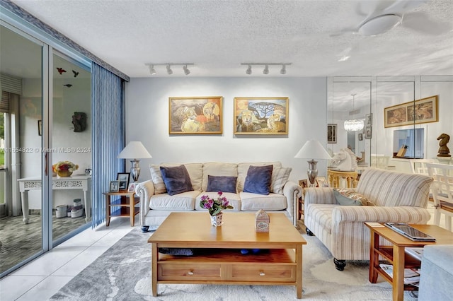 living room featuring a textured ceiling, rail lighting, and light tile patterned flooring