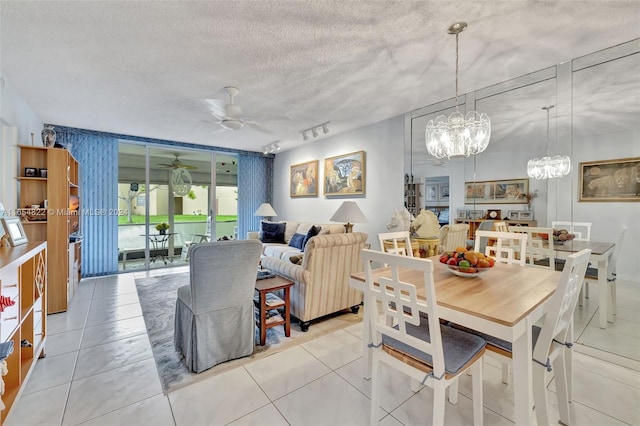 tiled dining space with a textured ceiling, floor to ceiling windows, and ceiling fan