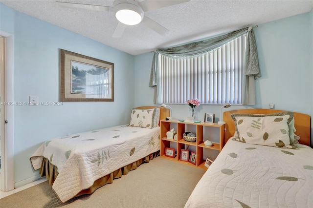 bedroom featuring a textured ceiling, ceiling fan, and carpet