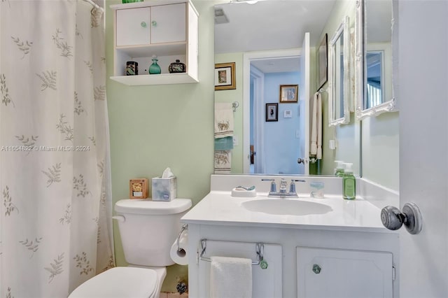 bathroom featuring vanity, toilet, and a shower with shower curtain