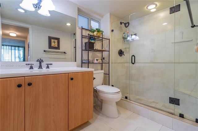 bathroom featuring vanity, toilet, and an enclosed shower