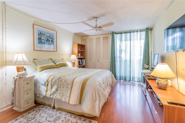 bedroom with a closet, ceiling fan, and hardwood / wood-style flooring