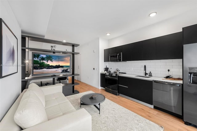 living area with light wood finished floors and recessed lighting