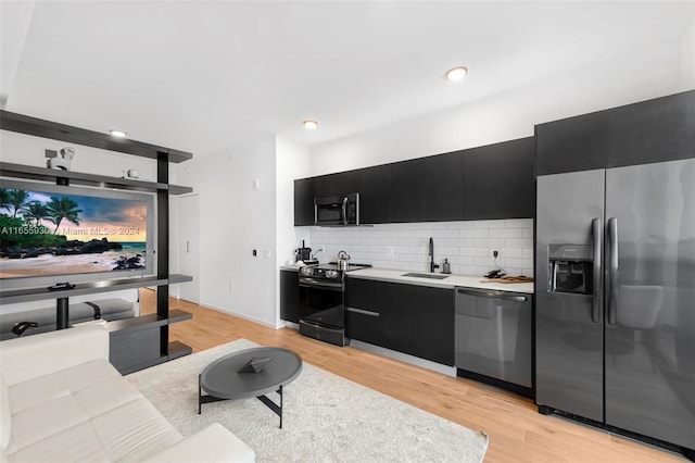 living area with recessed lighting and light wood-style flooring