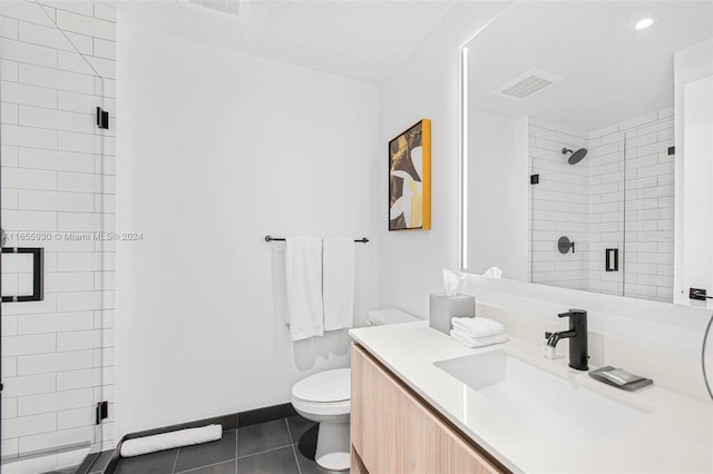 bathroom featuring visible vents, toilet, a shower stall, tile patterned flooring, and vanity