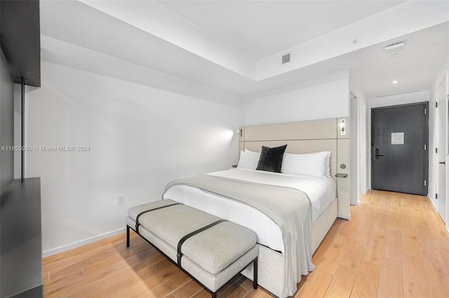 bedroom with visible vents, baseboards, and light wood-style floors