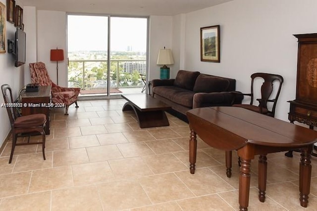 tiled living room featuring a wall of windows