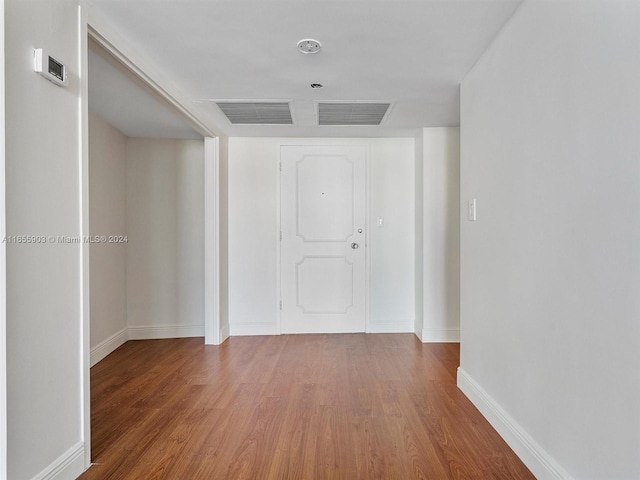 hallway with wood-type flooring