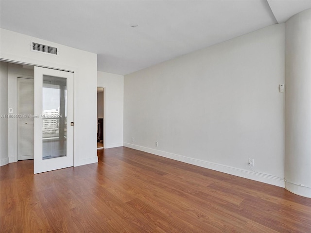 unfurnished bedroom with hardwood / wood-style flooring