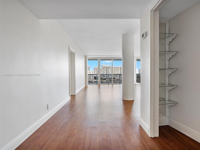 hall featuring floor to ceiling windows and wood-type flooring