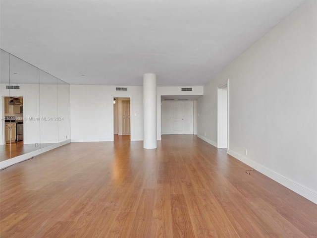 unfurnished living room with hardwood / wood-style flooring