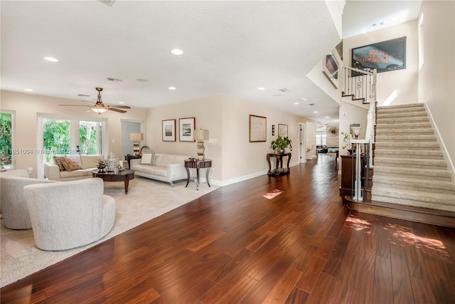 living room with hardwood / wood-style flooring and ceiling fan