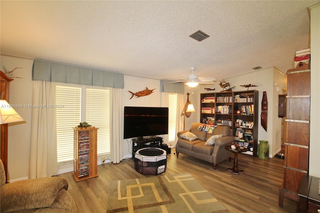 living room with ceiling fan, hardwood / wood-style flooring, a healthy amount of sunlight, and a textured ceiling