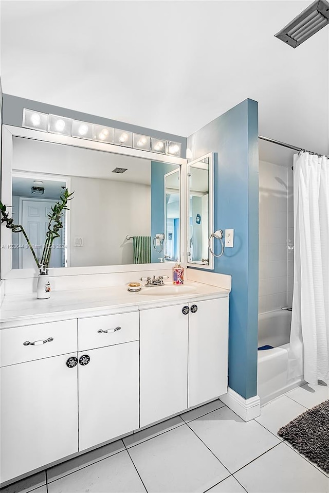 bathroom with vanity, tile patterned floors, and shower / bath combo with shower curtain