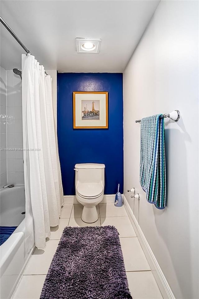 bathroom with toilet, tile patterned floors, and shower / bath combination with curtain