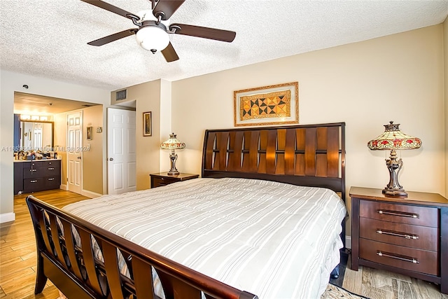 bedroom featuring a textured ceiling, ceiling fan, and light wood-type flooring