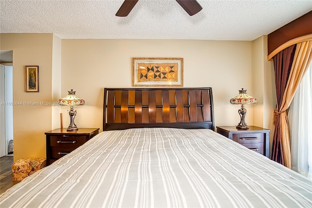 unfurnished bedroom with a textured ceiling, wood-type flooring, and ceiling fan