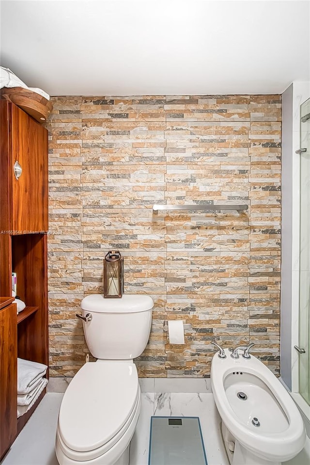 bathroom featuring toilet and a bidet