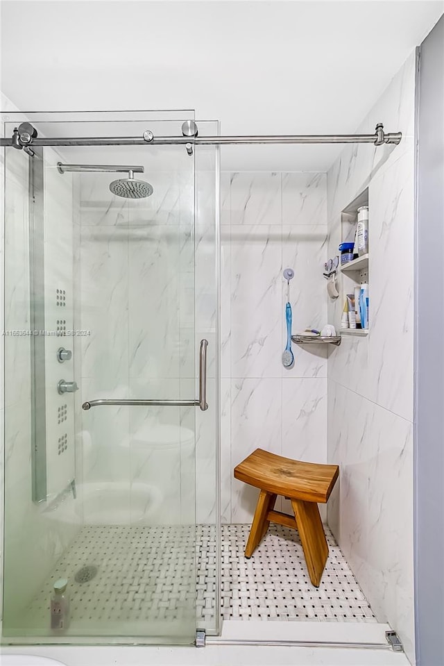 bathroom with tile walls and walk in shower