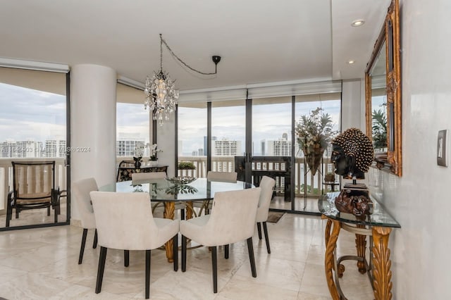 dining space with a chandelier, plenty of natural light, and expansive windows