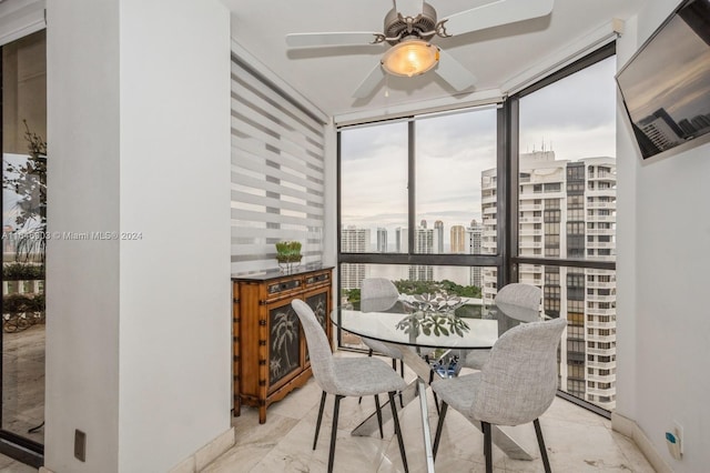 dining room with ceiling fan and expansive windows