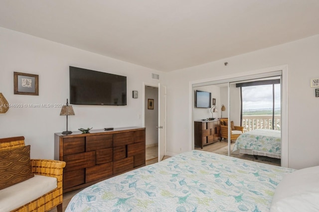 bedroom featuring access to outside and light hardwood / wood-style flooring