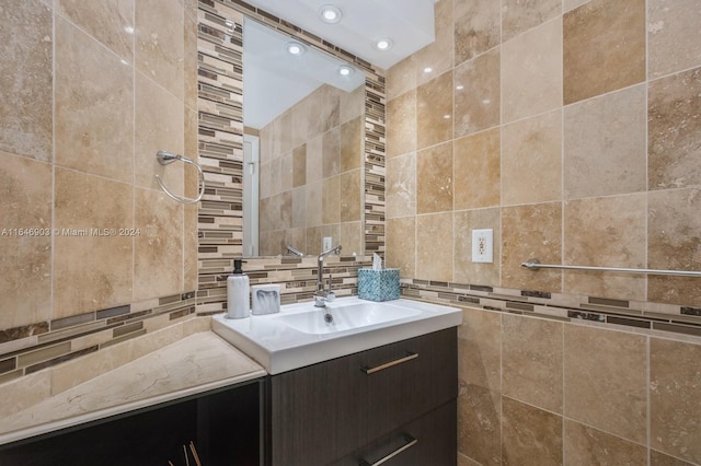 bathroom featuring tile walls and vanity