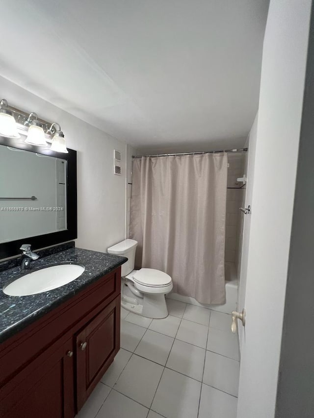 full bathroom featuring tile patterned flooring, vanity, toilet, and shower / tub combo with curtain