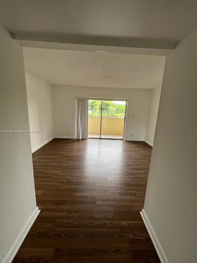 empty room featuring dark wood-type flooring