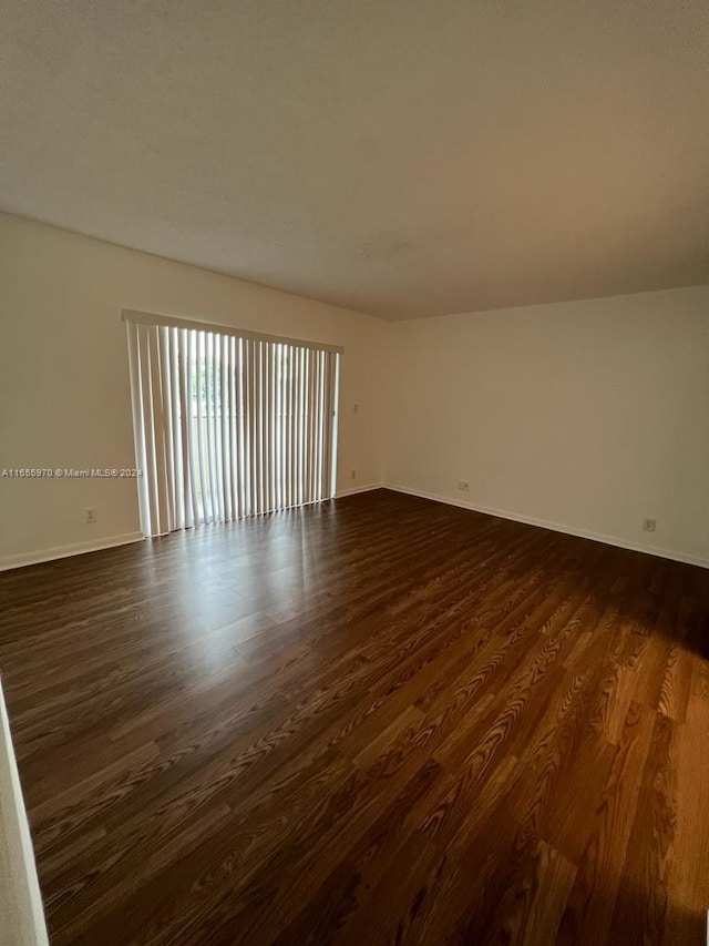 unfurnished bedroom with a closet, a textured ceiling, ceiling fan, and dark hardwood / wood-style floors