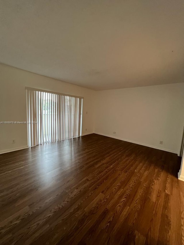 empty room with dark wood-type flooring