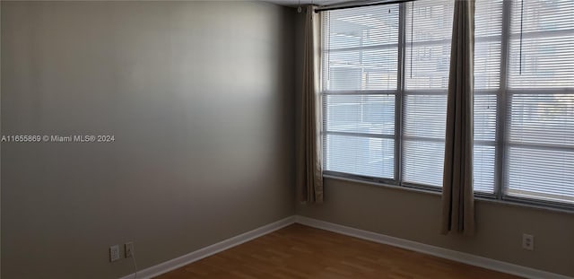 unfurnished room with plenty of natural light and hardwood / wood-style floors