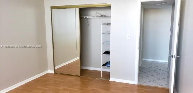 bedroom with a closet and light wood-type flooring