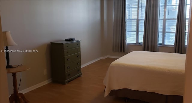 bedroom featuring multiple windows and wood-type flooring