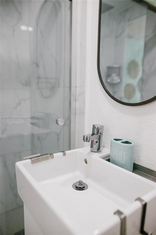 bathroom featuring vanity and a tile shower