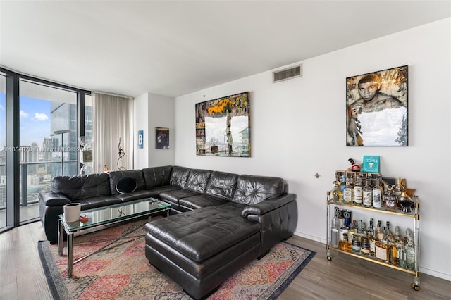 living room featuring a wall of windows and wood-type flooring