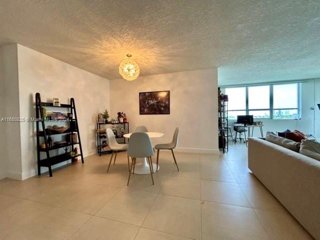 tiled dining room with a textured ceiling