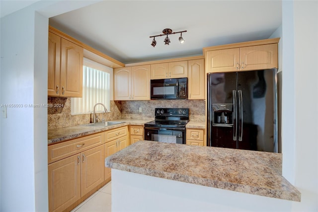 kitchen with light brown cabinetry, black appliances, and sink