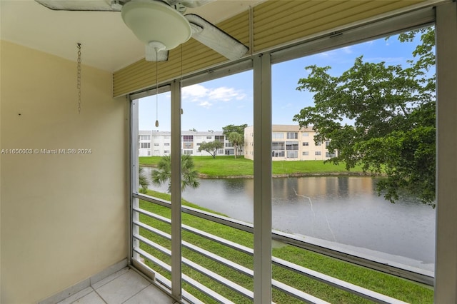 unfurnished sunroom with a water view