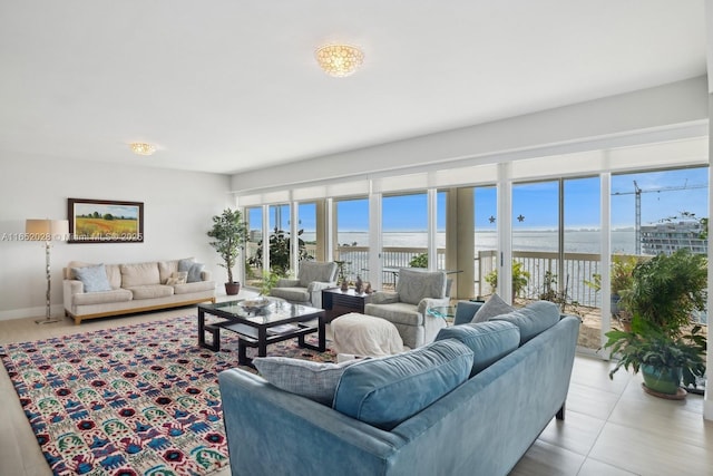 living room with a water view and light tile patterned floors