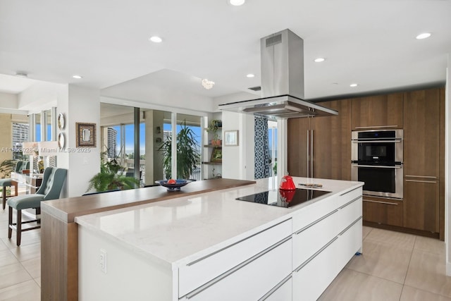 kitchen with light tile patterned floors, island exhaust hood, black electric stovetop, stainless steel double oven, and white cabinets