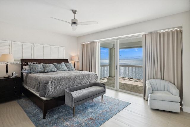 bedroom featuring a water view, access to exterior, and ceiling fan